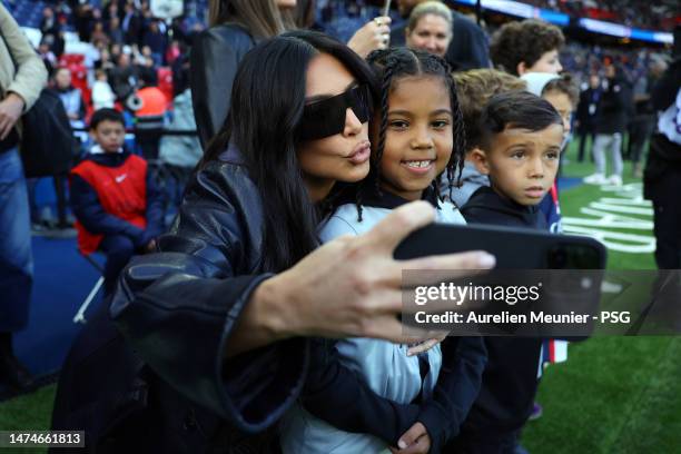 Saint West and Kim Kardashian attend the Ligue 1 match between Paris Saint-Germain and Stade Rennes at Parc des Princes on March 19, 2023 in Paris,...