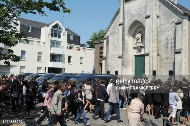 People gather outside the church of Saint Felix, in the French western city of Nantes to attend a funeral ceremony on April 28, 2011 in the memory of...