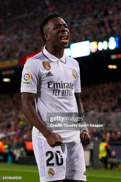 Vinicius Junior of Real Madrid celebrates their side's first goal, an own goal by Ronald Araujo of FC Barcelona during the LaLiga Santander match...