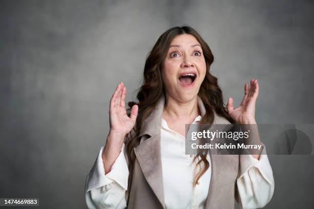 portrait of mature woman looking up in surprise - good news bad news stock pictures, royalty-free photos & images