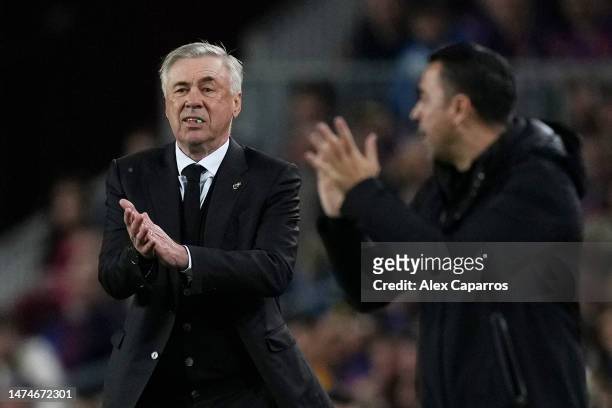 Carlo Ancelotti, Manager of Real Madrid, reacts alongside Xavi, Head Coach of FC Barcelona, during the LaLiga Santander match between FC Barcelona...