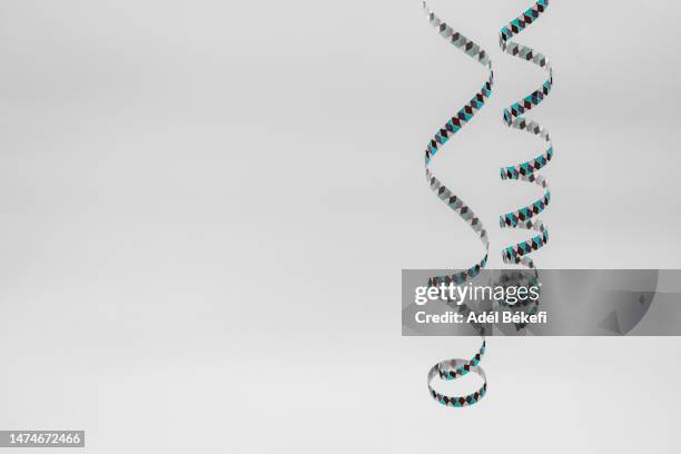 front view of coloful paper serpentine streamer on white background - party string stock pictures, royalty-free photos & images