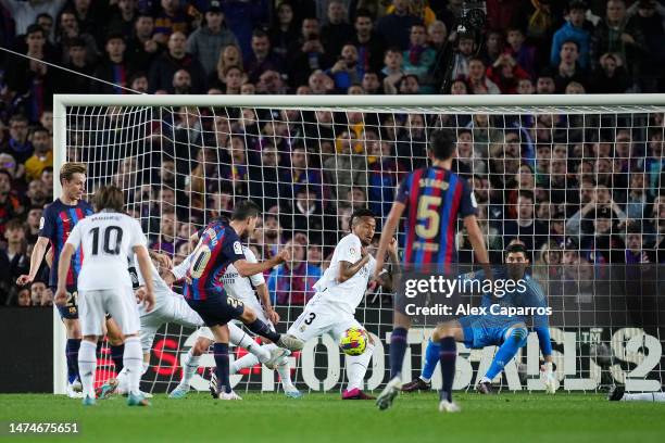 Sergi Roberto of FC Barcelona scores the team's first goal past Thibaut Courtois of Real Madrid during the LaLiga Santander match between FC...