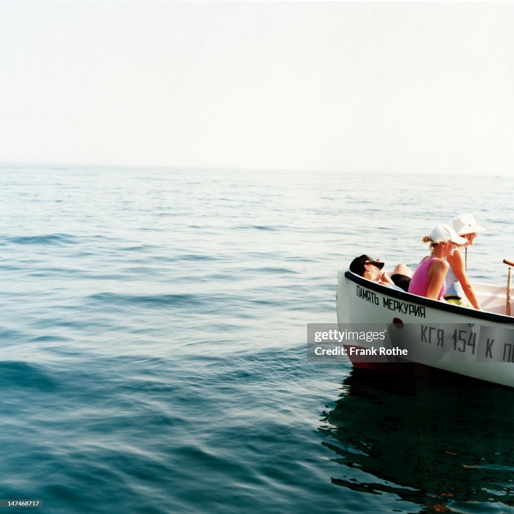 Three young kids in a boat on the Black Sea