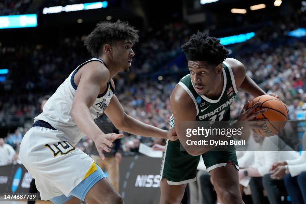 Hoggard of the Michigan State Spartans looks to pass against Stevie Mitchell of the Marquette Golden Eagles during the first half in the second round...
