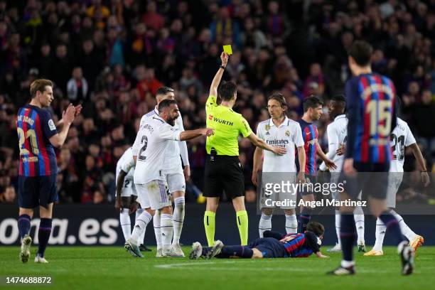 Luka Modric of Real Madrid is shown a yellow card by Referee De Burgos Bengoetxea during the LaLiga Santander match between FC Barcelona and Real...