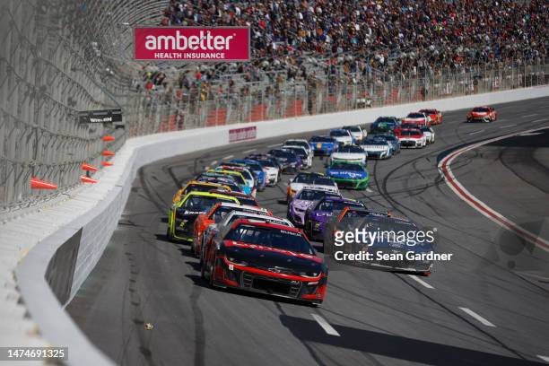 Kyle Busch, driver of the Lenovo Chevrolet, and Joey Logano, driver of the Autotrader Ford, lead the field during the NASCAR Cup Series Ambetter...