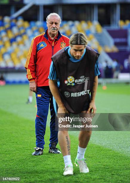 Head coach Vicente del Bosque of Spain stands behind Fernando Torres doing his warm up during a training session ahead of the UEFA EURO 2012 final...