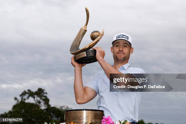 Taylor Moore of the United States celebrates with the trophy after winning during the final round of the Valspar Championship at Innisbrook Resort...