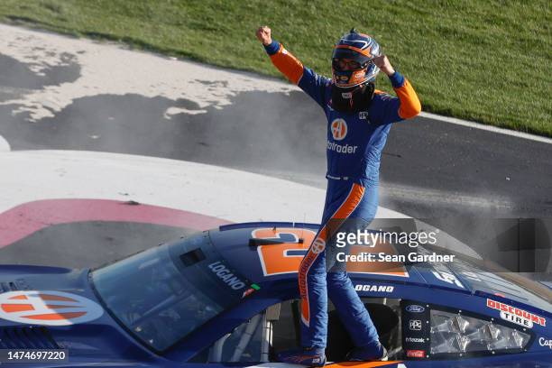 Joey Logano, driver of the Autotrader Ford, celebrates after winning the NASCAR Cup Series Ambetter Health 400 at Atlanta Motor Speedway on March 19,...