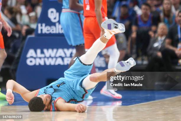 Devin Booker of the Phoenix Suns falls after being fouled while attempting a three point basket during the third quarter against the Oklahoma City...