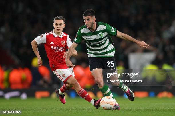 Goncalo Inacio of Sporting CP is challenged by Leandro Trossard of Arsenal during the UEFA Europa League round of 16 leg two match between Arsenal FC...