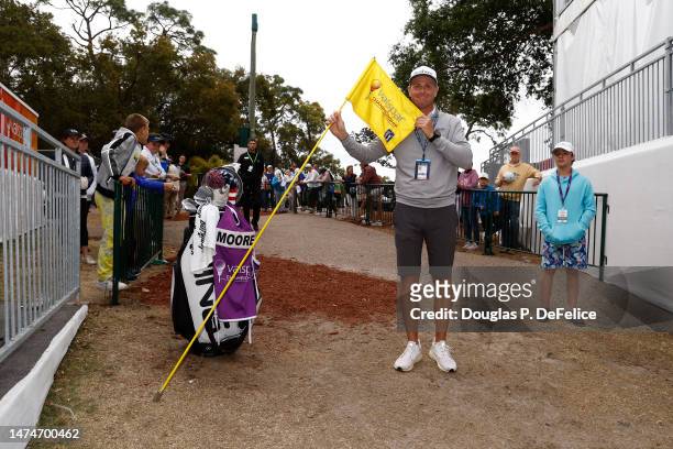 Caddie Chris Tichenor celebrates with the flag after he and Taylor Moore of the United Statesf won during the final round of the Valspar Championship...
