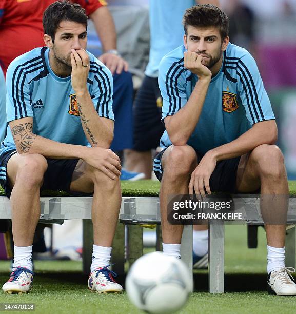 Spanish midfielder Cesc Fabregas and Spanish defender Gerard Pique are pictured before a training session on June 30, 2012 at the Olympic Stadium in...