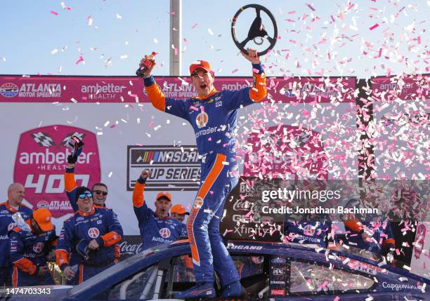 Joey Logano, driver of the Autotrader Ford, celebrates in victory lane after winning the NASCAR Cup Series Ambetter Health 400 at Atlanta Motor...