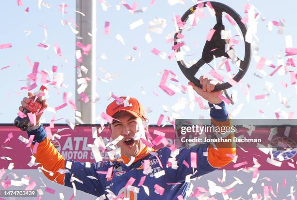 Joey Logano, driver of the Autotrader Ford, celebrates in victory lane after winning the NASCAR Cup Series Ambetter Health 400 at Atlanta Motor...