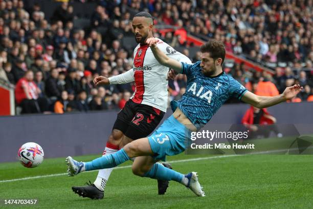 Theo Walcott of Southampton is tackled by Ben Davies of Tottenham Hotspur during the Premier League match between Southampton FC and Tottenham...