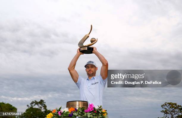 Taylor Moore of the United States celebrates with the trophy after winning during the final round of the Valspar Championship at Innisbrook Resort...