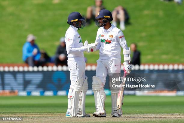 Dinesh Chandimal of Sri Lanka celebrates his half century with Dhananjaya De Silva of Sri Lanka during day four of the Second Test Match between New...