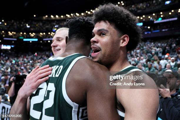 Mady Sissoko and Malik Hall of the Michigan State Spartans celebrate after defeating the Marquette Golden Eagles in the second round game of the NCAA...