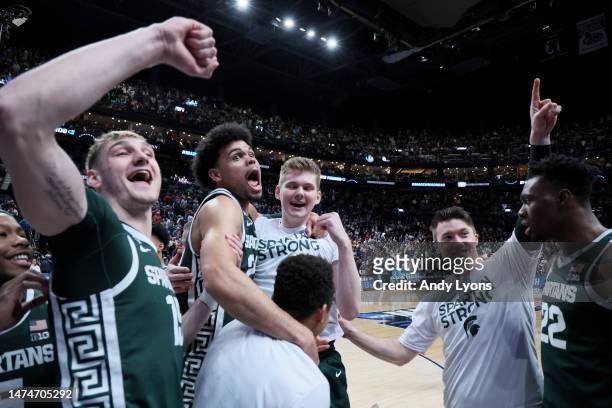 The Michigan State Spartans celebrate after defeating the Marquette Golden Eagles in the second round game of the NCAA Men's Basketball Tournament at...