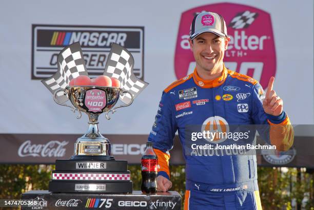 Joey Logano, driver of the Autotrader Ford, celebrates in victory lane after winning the NASCAR Cup Series Ambetter Health 400 at Atlanta Motor...