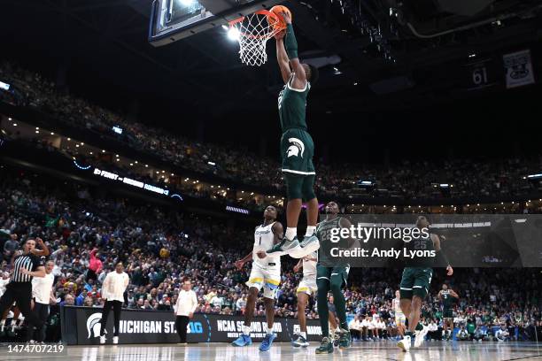 Tyson Walker of the Michigan State Spartans dunks the ball against the Marquette Golden Eagles during the second half in the second round game of the...