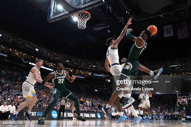 Tyson Walker of the Michigan State Spartans shoots the ball against Oso Ighodaro of the Marquette Golden Eagles during the second half in the second...