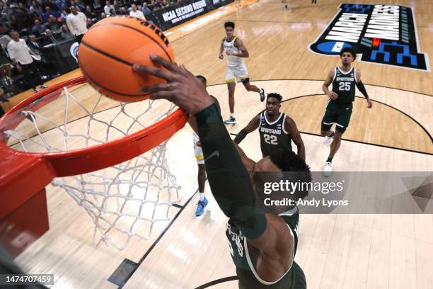 Tyson Walker of the Michigan State Spartans dunks the ball against the Marquette Golden Eagles during the second half in the second round game of the...