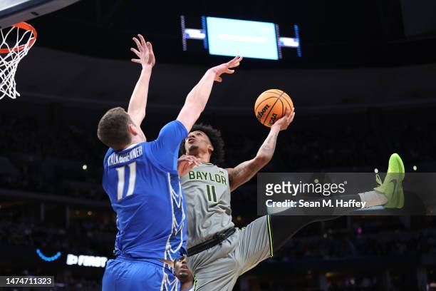 Jalen Bridges of the Baylor Bears drives to the basket against Ryan Kalkbrenner of the Creighton Bluejays during the second half in the second round...