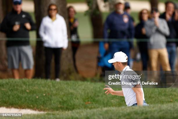 Taylor Moore of the United States waves after hitting from a bunker on the 17th hole during the final round of the Valspar Championship at Innisbrook...