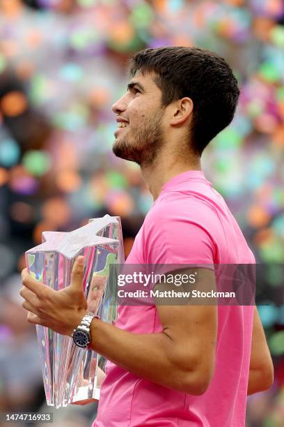 Carlos Alcaraz of Spain poses with the trophy after def4eating Daniil Medvedev of Russia during the Men's Final of the BNP Paribas Open at the Indian...