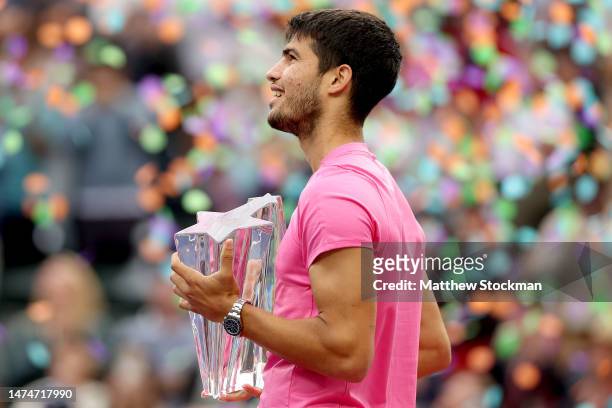 Carlos Alcaraz of Spain poses with the trophy after def4eating Daniil Medvedev of Russia during the Men's Final of the BNP Paribas Open at the Indian...