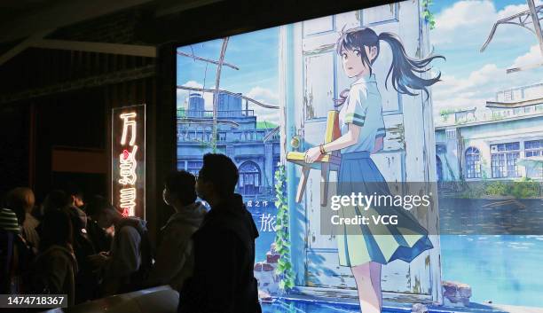 Audience walk past by a poster of animated film "Suzume" directed by Japanese animator Makoto Shinkai at Wanda Cinema on March 19, 2023 in Shanghai,...