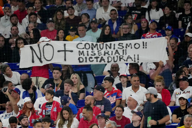 Fans hold up signs during the World Baseball Classic Semifinals between Team USA and Team Cuba at loanDepot park on March 19, 2023 in Miami, Florida.