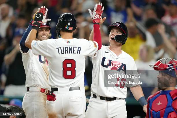 Trea Turner of Team USA celebrates with Will Smith and Jeff McNeil after hitting a three-run home run in the sixth inning against Team Cuba during...