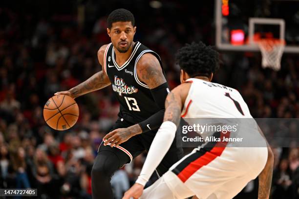 Paul George of the Los Angeles Clippers dribbles against Anfernee Simons of the Portland Trail Blazers during the second quarter at the Moda Center...