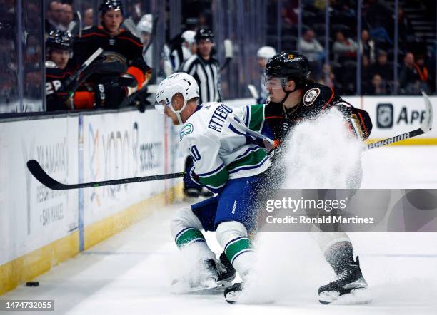 Elias Pettersson of the Vancouver Canucks skates the puck against Frank Vatrano of the Anaheim Ducks in the third period at Honda Center on March 19,...