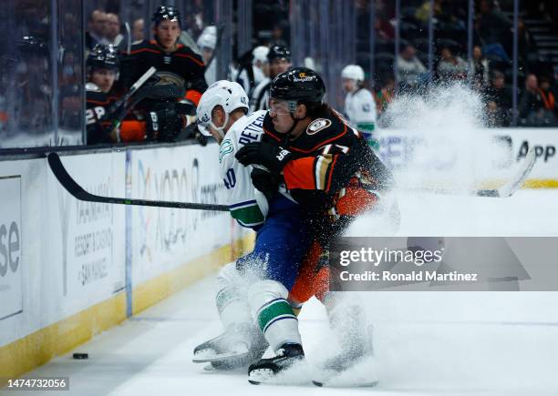 Elias Pettersson of the Vancouver Canucks skates the puck against Frank Vatrano of the Anaheim Ducks in the third period at Honda Center on March 19,...