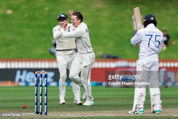 Michael Bracewell of New Zealand celebrates with Tom Latham after taking the wicket of Dhananjaya De Silva of Sri Lanka during day four of the Second...