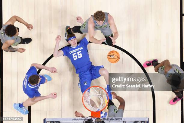 Caleb Lohner of the Baylor Bears and Baylor Scheierman of the Creighton Bluejays battle in the lane during the first half in the second round of the...