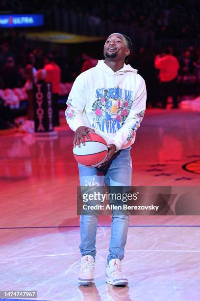 Asante Samuel shoots a basketball at halftime of a basketball game between the Los Angeles Lakers and the Orlando Magic at Crypto.com Arena on March...