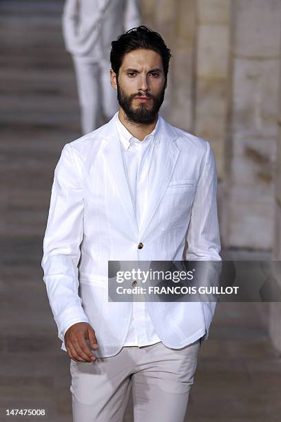 Model displays creations by French designer Veronique Nichanian for the label Hermes during the men's spring-summer 2013 fashion collection show on...