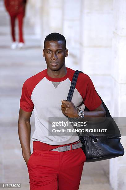 Model displays creations by French designer Veronique Nichanian for the label Hermes during the men's spring-summer 2013 fashion collection show on...