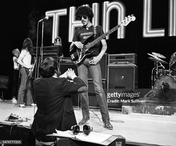 Thin Lizzy singer Phil Lynott speaks with producer Ken Ehrlich during The Midnight Special rehearsal at NBC Studios, Burbank, CA on October 24, 1976.