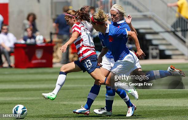 Alex Morgan of the USA out runs Canada Kaylyn Kyle and Carmelina Moscato of Canada during the first half of the women's Olympic send-off soccer match...