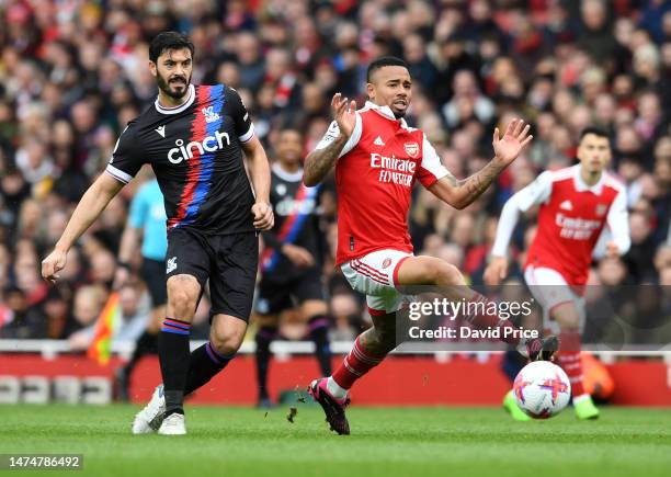 Gabriel Jesus of Arsenal is challenged by James Tomkins of Palace during the Premier League match between Arsenal FC and Crystal Palace at Emirates...