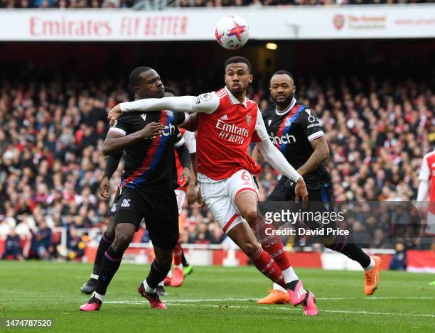 Gabriel Magalhaes of Arsenal is challenged by Tyrick Mitchell of Palace during the Premier League match between Arsenal FC and Crystal Palace at...