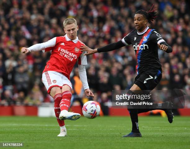 Oleksandr Zinchenko of Arsenal passes the ball under pressure from Michael Olise of Palace during the Premier League match between Arsenal FC and...
