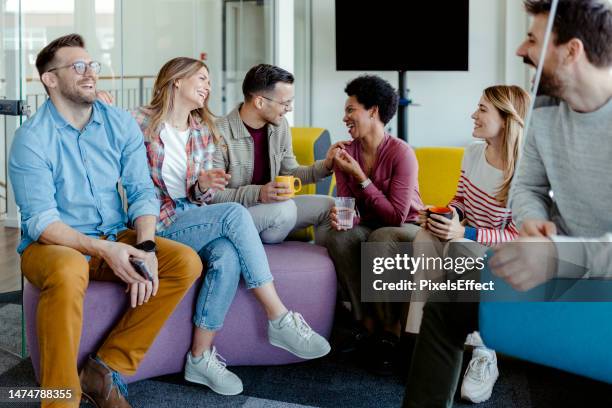 colleague taking break in modern office break out area - office sitting stock pictures, royalty-free photos & images